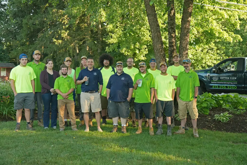 Green World landscaping crew standing together on a finished lawn